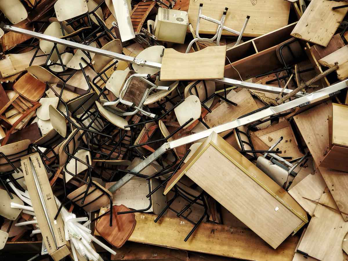Pile of old furniture and household junk cleared out during a basement cleanout