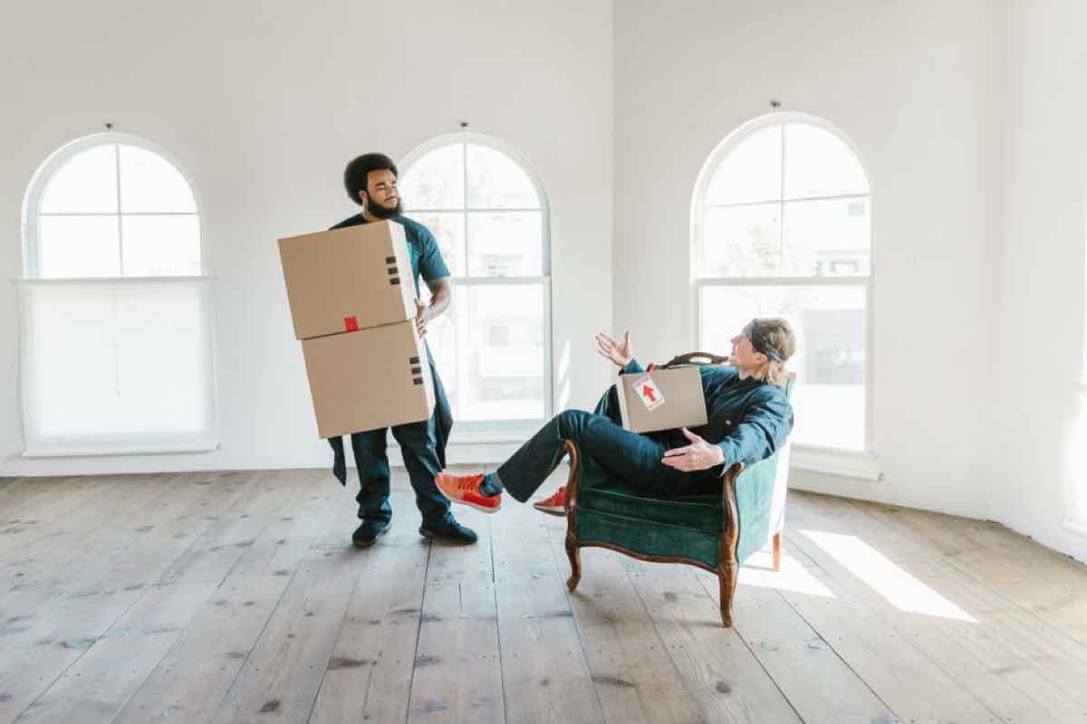 Empty apartment unit with moving boxes and furniture, being cleared for turnover