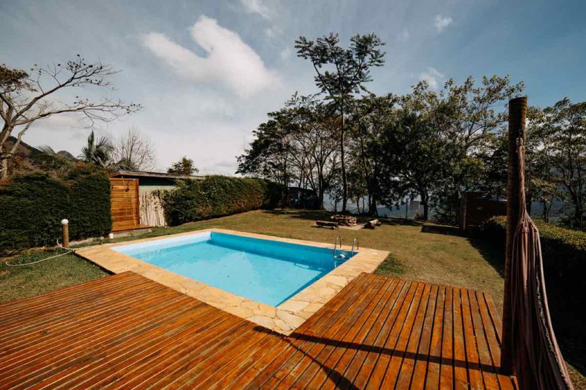 Wooden deck attached to a backyard pool area