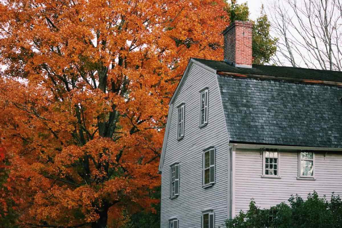 Classic New England colonial-style home with fall foliage, the kind of property involved in a South Shore estate cleanout
