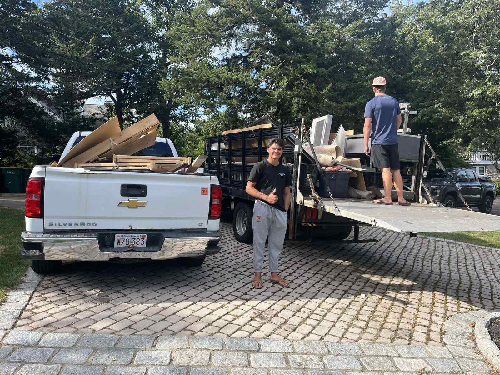 Dumpster Dudes crew giving a thumbs up after a completed job in Braintree, MA