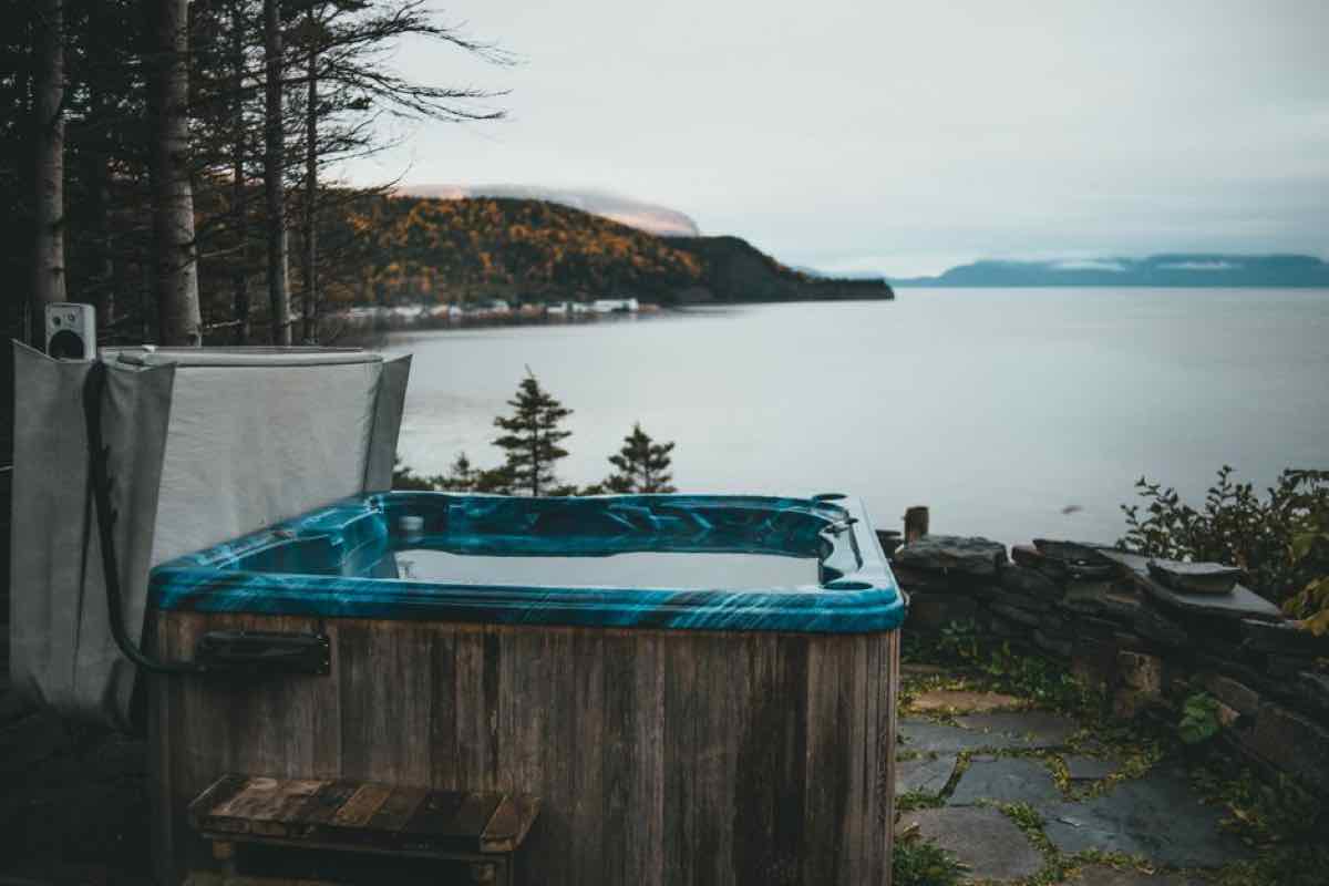 Built-in wood hot tub on a coastal deck with ocean view