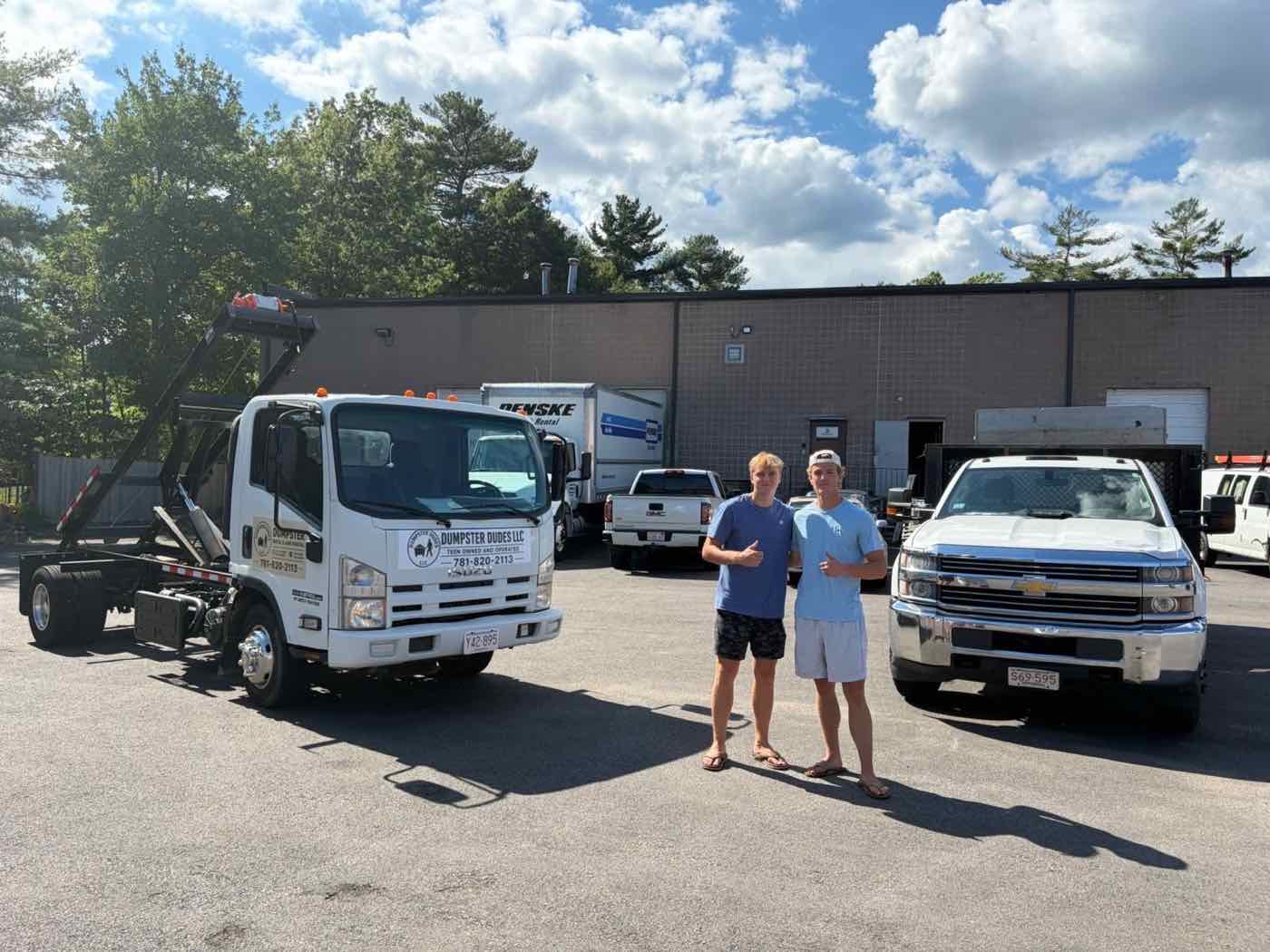 Dumpster Dudes crew standing with roll-off truck and dumpster, ready to quote a job