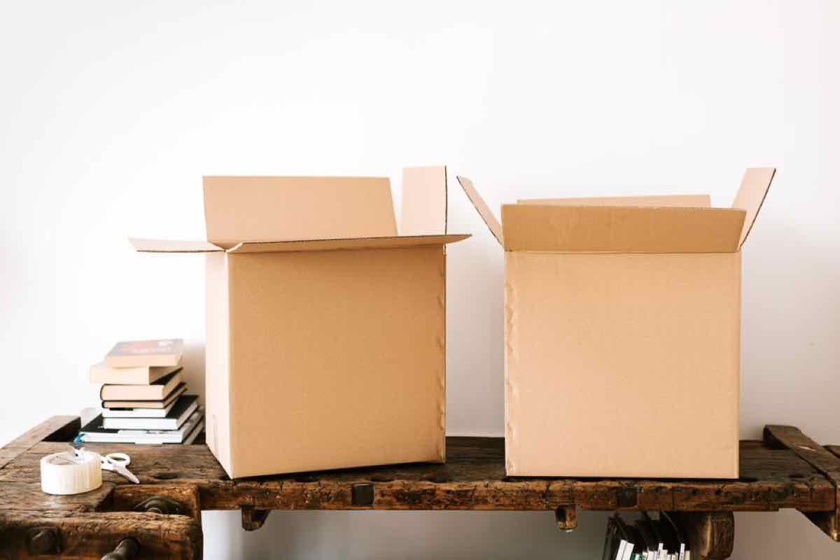 Stack of packed boxes and books on a desk during an office move