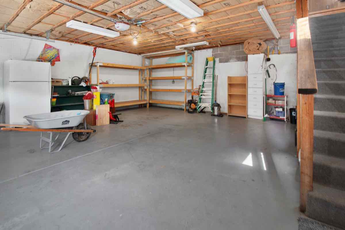 Garage shelving with old paint cans and chemicals typical of household hazardous waste